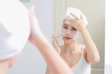 Asian woman cleaning face skin enjoy herself with bubble cleansing foam.の写真素材