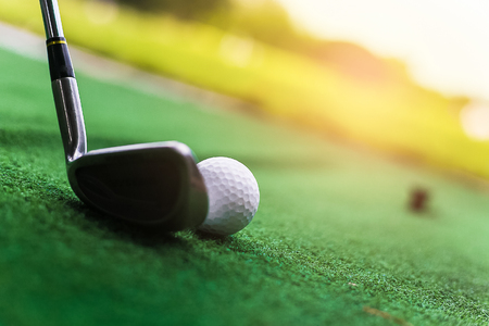 Golf club and ball in green grass.の写真素材