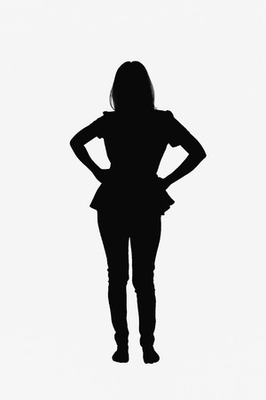 Motion concept - Young woman standing akimbo on white background.の写真素材