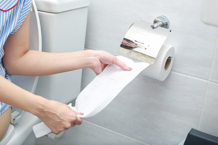 Close-up of a hand using toilet paper.の写真素材