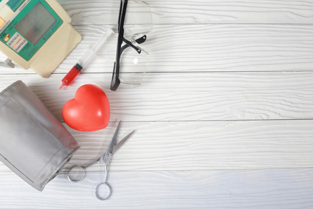 Equipments on table with medicines, stethoscope and glasses, top viewの写真素材