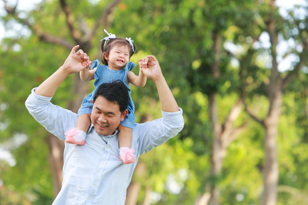 Father and daughter walking on the park.の写真素材