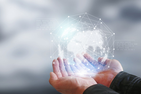Businessman holding in hand with global connection concept.の写真素材