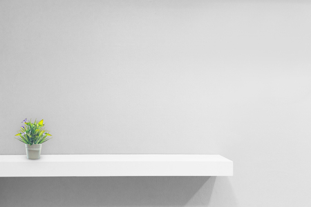 Empty white shop shelf, retail shelf on grey vintage background.の写真素材