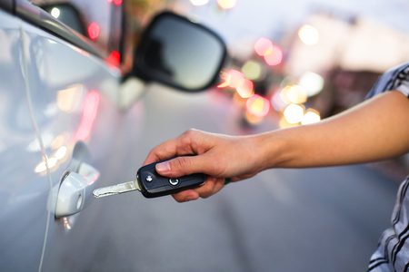 Hand of woman open with the key car.の写真素材