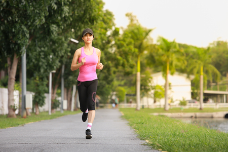 Young fitness woman running in the park.の写真素材