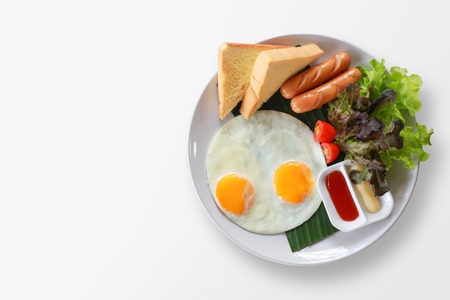Breakfast on plate, fried eggs with vegetables on top.の写真素材