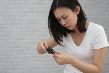Damaged Hair. Young girl unhappy with her damaged and dry hair.の写真素材