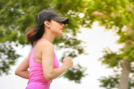 Young fitness woman running in the park.の写真素材
