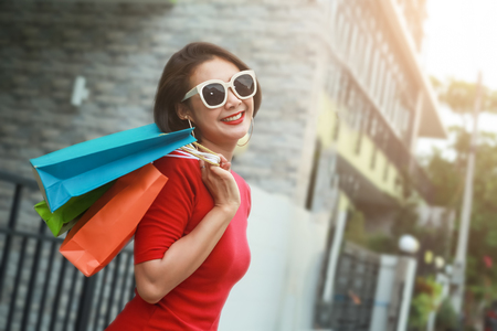 Happy woman with shopping bags enjoying in shopping outdoor.の写真素材