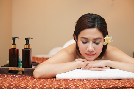 Beautiful young woman receiving massage in spa salon.の写真素材