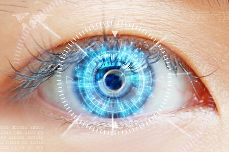 Close-up of woman's brown eye. High Technologies in the futureの写真素材