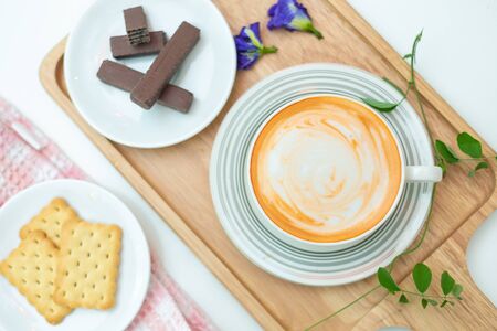 Hot thai tea  with dessert and white plate. on topの写真素材
