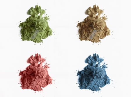 Four various heaps of protein powder isolated on white background.の写真素材