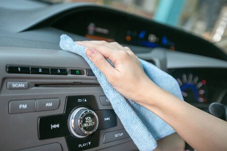 Hand cleaning Interior modern car with Microfiber and cleaning console car.の写真素材