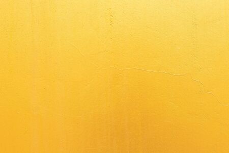 Gold concrete background with light reflections. Golden textured wall.の写真素材