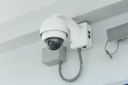 Modern CCTV camera on a wall in the airport.の写真素材