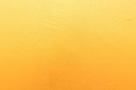 Gold concrete background with light reflections. Golden textured wall.の写真素材