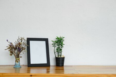 Soft home decor, vase with green small flowers on a white vintage wall background.の写真素材
