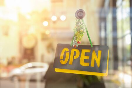 Open sign hanging front of cafe with colorful bokeh light background. Business serviceの写真素材