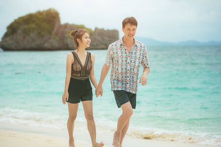 Beach couple lover walking on the beach honeymoon vacation summer holidays romance.の写真素材