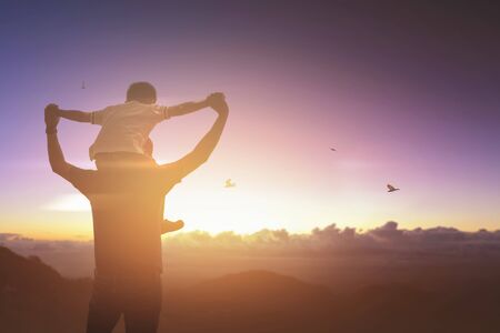 Son riding back his father with outdoors on sunset. Father holidayの写真素材