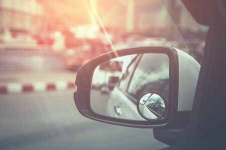 Side rear-view in left mirror on a car. vintage toneの写真素材