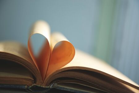 Book page in heart shape with old paper.の写真素材