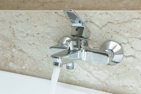 Luxury  bath tub and faucet with water.の写真素材