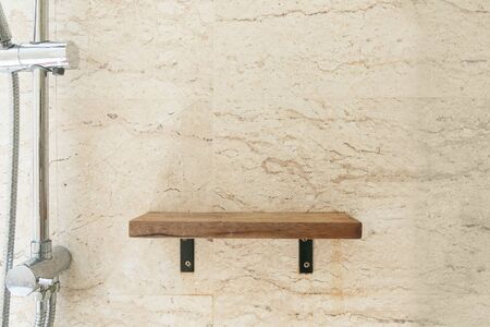 Wooden shelf on the wall in bathroom.の写真素材