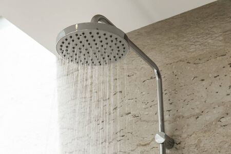 Close up of water shower faucet in the bathroom.の写真素材