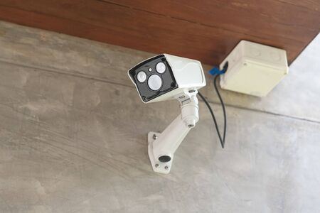 Modern CCTV camera on a wall in the airport.の写真素材