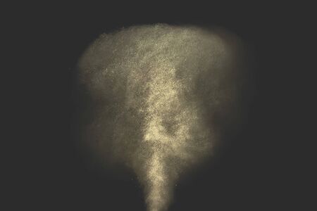 Gold dust glitter shooting spray on black background.の写真素材