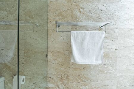 Clean towels on rack in the bathroom.