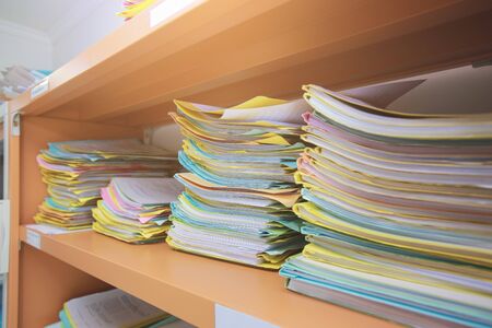 Stacks of paper files information on work desk office. Business conceptの写真素材