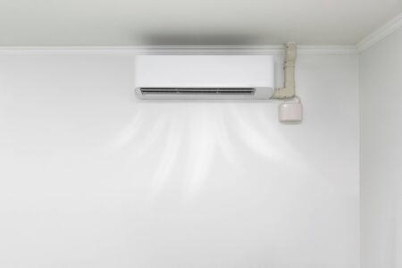 Air conditioner blowing cold air in the room.の写真素材