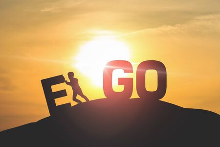 Silhouette of man push EGO with sky and sun light background. の写真素材
