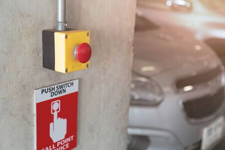Emergency Alarm button at car park complex for security alert and crime control.の写真素材