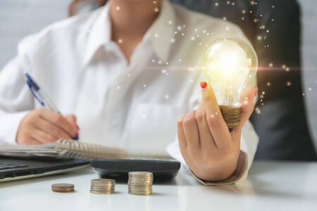 Business woman hand holding light bulb have a new ideas.の写真素材