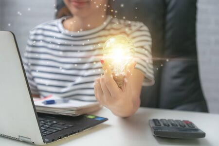 Business woman hand holding light bulb have a new ideas.の写真素材