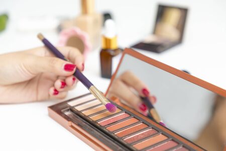 Closeup of hand makeup artist testing different eyeshadows.の写真素材