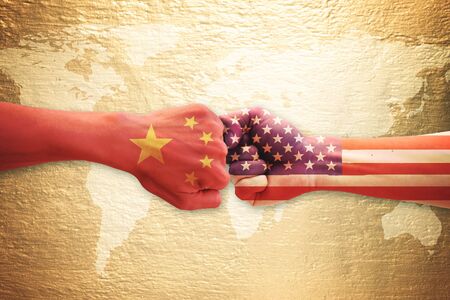 Two hands punch with China and USA flag over world map. Concept of trade war.の写真素材