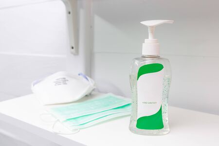 Coronavirus prevention medical surgical masks and hand sanitizer. hygiene concept.の写真素材