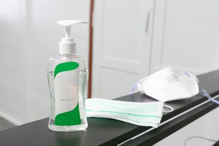 Coronavirus prevention medical surgical masks and hand sanitizer. hygiene concept.の写真素材