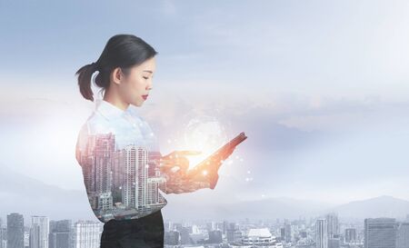 Attractive business lady working on tablet. Innovation technology conceptの写真素材