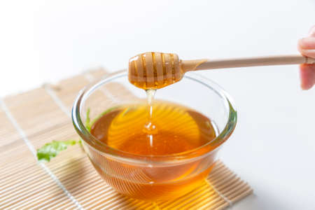 Fresh honey bee in bowl on white background.の写真素材