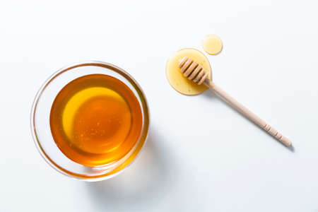 Fresh honey bee in bowl on white background. top viewの写真素材