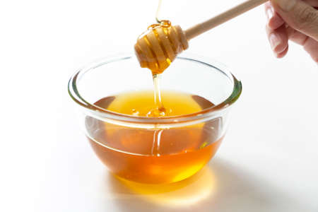 Fresh honey bee in bowl on white background.の写真素材