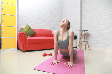 Asian woman practice cobra asana in class.Calmness and relax.の写真素材