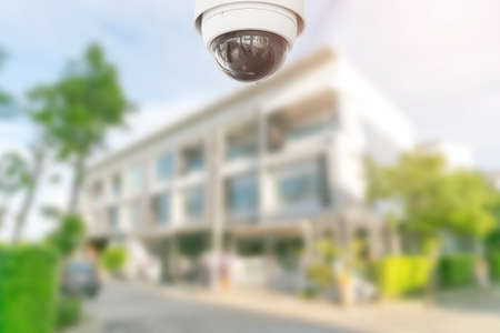 Security CCTV camera with home on background.の写真素材
